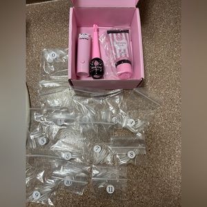 Gel nail kit w/curing lamp, 11 sizes of forms & base gel.  Brand new in the box.